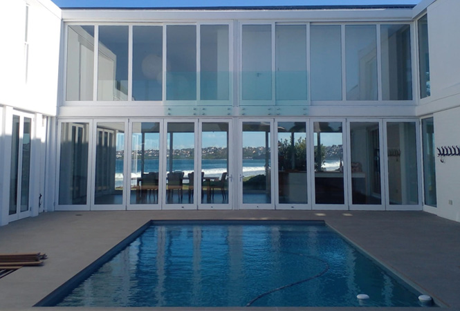 Modern double-storey luxury home with a swimming pool, custom-built by Prism Construction