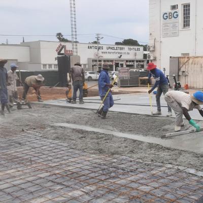 Prism Construction Team Pouring Cement Foundation